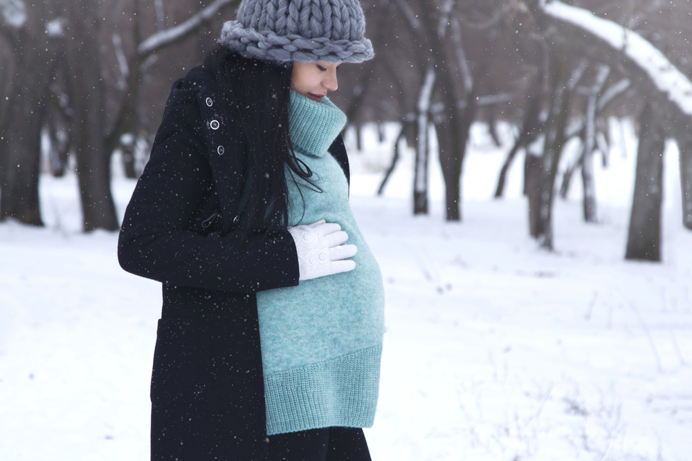 pregnant woman walking in the snow
